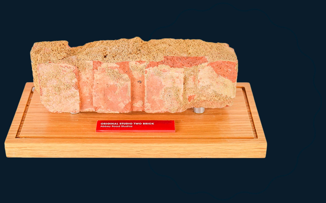 Vintage brick wall with %22Original Studio%22 logo